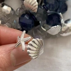 Elegante anello aperto in argento con stella marina e conchiglia dal design marino
