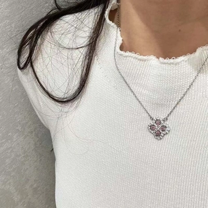 Detail of clover pendant with pink pear-cut stones and white zircon pavé setting