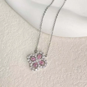 Pink four-leaf clover pendant necklace with sparkling zircons on a silver chain
