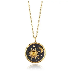 Golden sun and moon medallion necklace with a yellow gemstone on a dainty chain