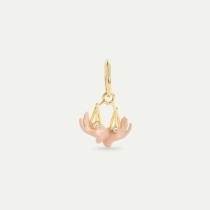 Detailed view of gold Libra pendant featuring pink enamel and two sparkling crystals