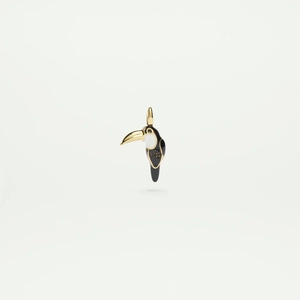 Detailed view of enamel toucan pendant with gold accents and brand engraving