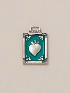 Detailed view of vintage silver rectangle pendant with teal enamel and heart motif