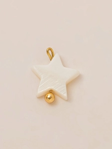 Detailed view of a star-shaped mother of pearl pendant with gold-plated metal hook and bead