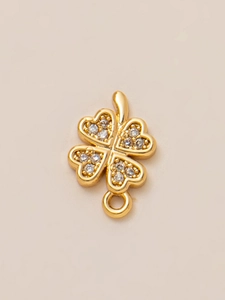 Macro shot of 18K gold plated clover pendant with heart-shaped leaves and cubic zirconia