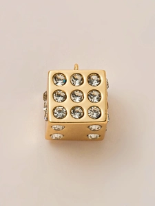 Detailed view of a gold-plated dice pendant with sparkling crystal inlay and hanging ring