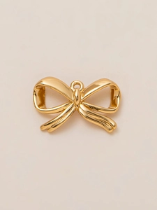 Detailed view of a 18K gold-plated bow charm pendant for DIY jewelry and accessories