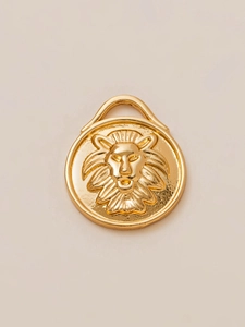 Macro detail of 18K gold-plated lion head pendant with relief carving and ring hook