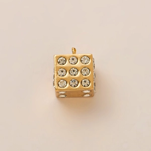Macro shot of 18K gold plated dice pendant with sparkling white rhinestone embellishments