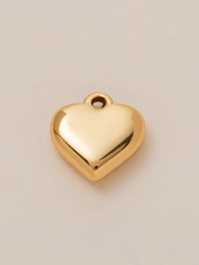Detailed view of a 3D heart-shaped 18K gold-plated pendant with polished mirror finish