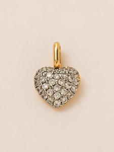 Macro shot of gold heart pendant featuring micro-pave cubic zirconia gemstones