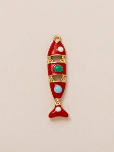 Dettaglio di un ciondolo a forma di pesce articolato con smalto rosso e pietre colorate