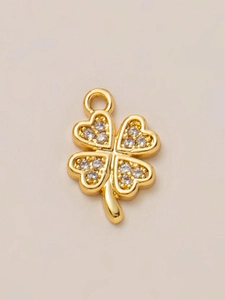 Macro view of four-leaf clover pendant with 18K gold plating and pave zircon heart petals