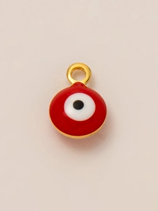 Macro detail of red enamel evil eye pendant with 18K gold plated frame and ring hook