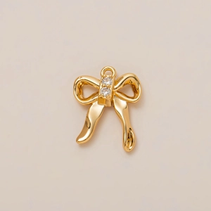 Polished 18K gold bow pendant charm with two sparkling zircons and a secure top loop