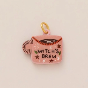 Detail of pink Witch's Brew mug pendant with gold ring and enamel finish