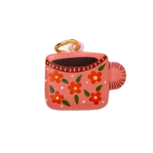 Pink cartoon cup charm with orange floral patterns and golden ring pendant attachment