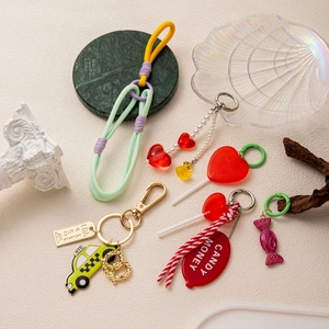 Handmade beaded keychains with colorful charms and woven ropes for stylish handbags