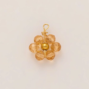 Detail of 18K gold plated flower pendant with champagne crystal beads and golden wire
