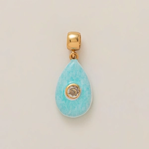 Detail of light blue teardrop pendant with gold-plated clasp and cubic zirconia inlay