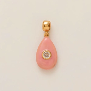 Macro shot of pink drop pendant with central cubic zirconia and gold polished bail