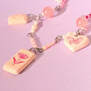 Pastel pink beaded necklace with butterfly heart ceramic charms and 18K gold plated chain