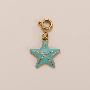 Macro view of a gold-plated starfish pendant with light blue enamel and textured gold dots