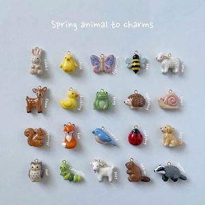 Detailed grid of assorted ceramic animal charms with 18K gold plated hanging rings