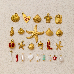 Close-up of assorted 18k gold plated ocean themed DIY charms and pendants for jewelry making