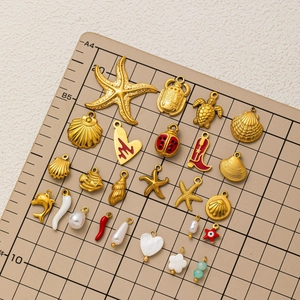 Variety of 18k gold plated stainless steel ocean themed charms and pendants for DIY jewelry