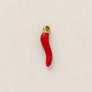 Detailed macro view of a red chili pendant with 18k gold plated metal loop for DIY jewelry