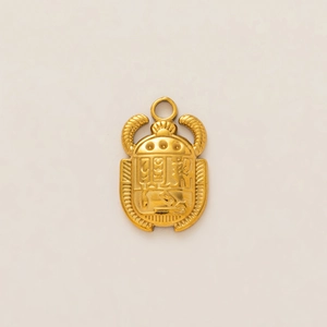 Macro shot of 18k gold plated stainless steel scarab pendant with ancient hieroglyphs