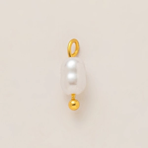 Macro detail of baroque pearl pendant with 18k gold plated stainless steel parts