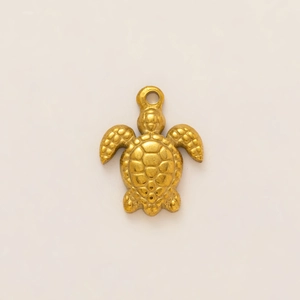 Detailed close-up of a 18k gold-plated stainless steel turtle charm for DIY jewelry making