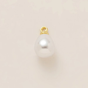Macro detail of a white teardrop pearl pendant with 18k gold-plated stainless steel ring