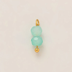 Detailed macro view of mint blue faceted beads with 18k gold-plated metal connections