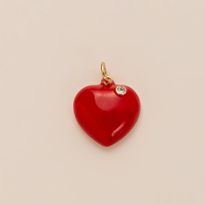 Detail of red heart pendant with gold plating and a sparkling white zircon stone inlay