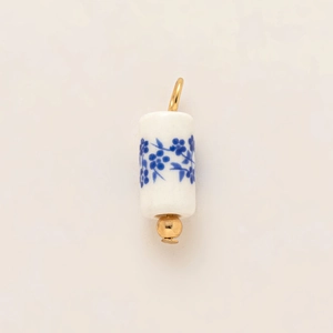 Detail of blue floral ceramic pendant with 18k gold plating and stainless steel ring