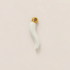 Detail of a curved white ceramic Italian horn pendant with a 18k gold-plated ring attachment