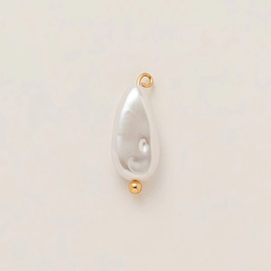 Detailed macro view of a teardrop pearl pendant with 18k gold plated stainless steel accents