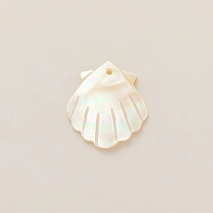 Macro detail of a 18k gold plated shell pendant with mother of pearl texture