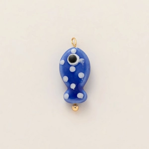 Detail of blue fish evil eye pendant with 18k gold-plated accents and white polka dots