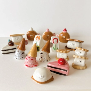 Cute ceramic cartoon dessert charms featuring smiley faces like cake, donut, and sandwich