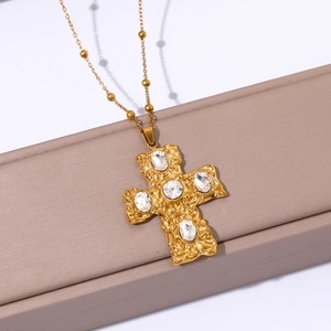 Detail of 18k gold plated cross pendant with lava texture and 5 oval crystals on beaded chain