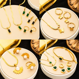 Four sets of vintage gold-tone titanium steel jewelry with green gemstones and pearls