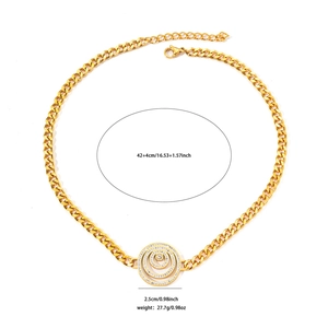 Detailed view of golden Cuban chain with crystal encrusted circular pendant and clasp