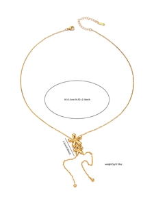 Details einer goldenen Halskette mit Blumenanhänger, langen Quasten und Karabiner