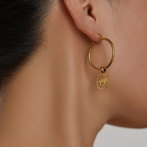 Polished gold oversized hoop earrings featuring a heart and heartbeat pulse design charm