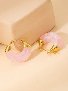 Macro shot of pink marble resin hoop earrings with polished 18K gold-plated metal ends