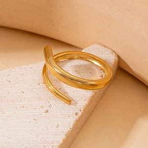 Detailed macro view of a minimalist double-layer spiral gold-plated stainless steel ring